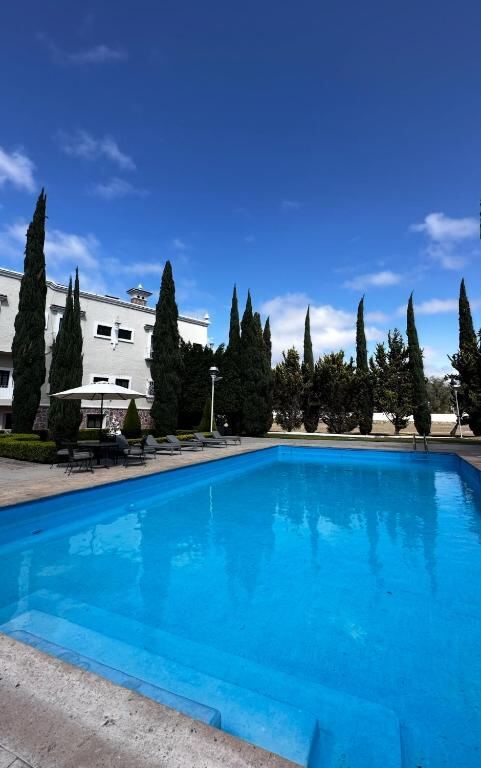 Outdoor swimming pool under blue skies